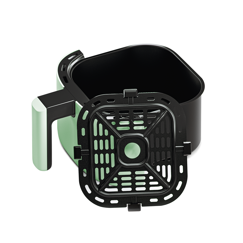 Sage green air fryer basket tilted to show the removable crisper plate inside