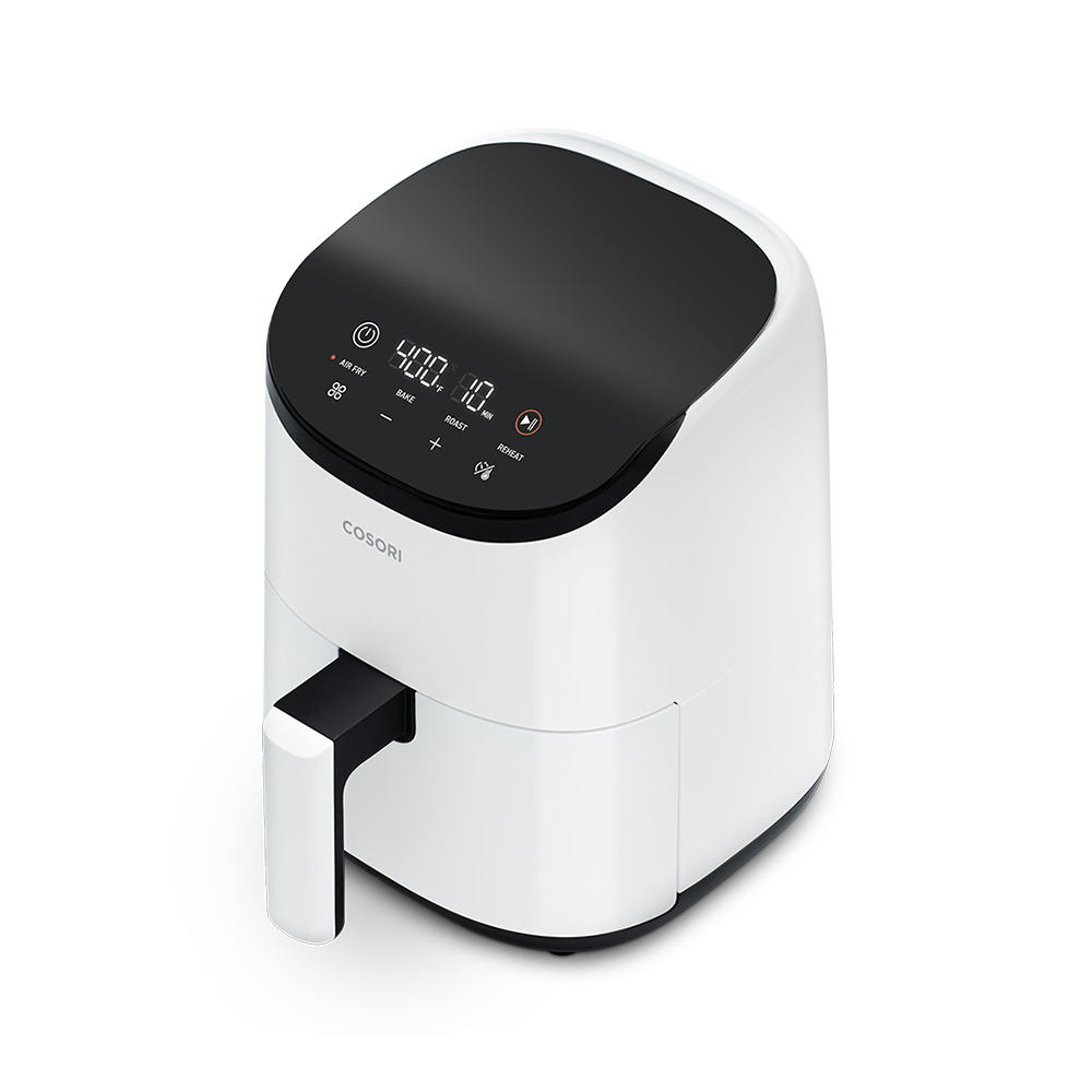 Angled view of the white Cosori Lite 2.1-Quart Mini Air Fryer, ideal for bright kitchen aesthetics.