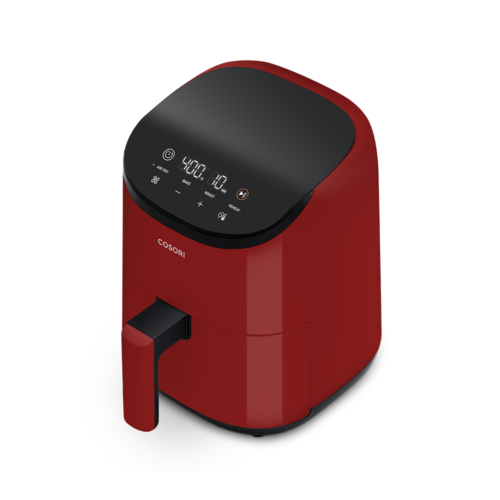 Angled front view of the red Cosori Lite 2.1-Quart Mini Air Fryer showing its matte finish