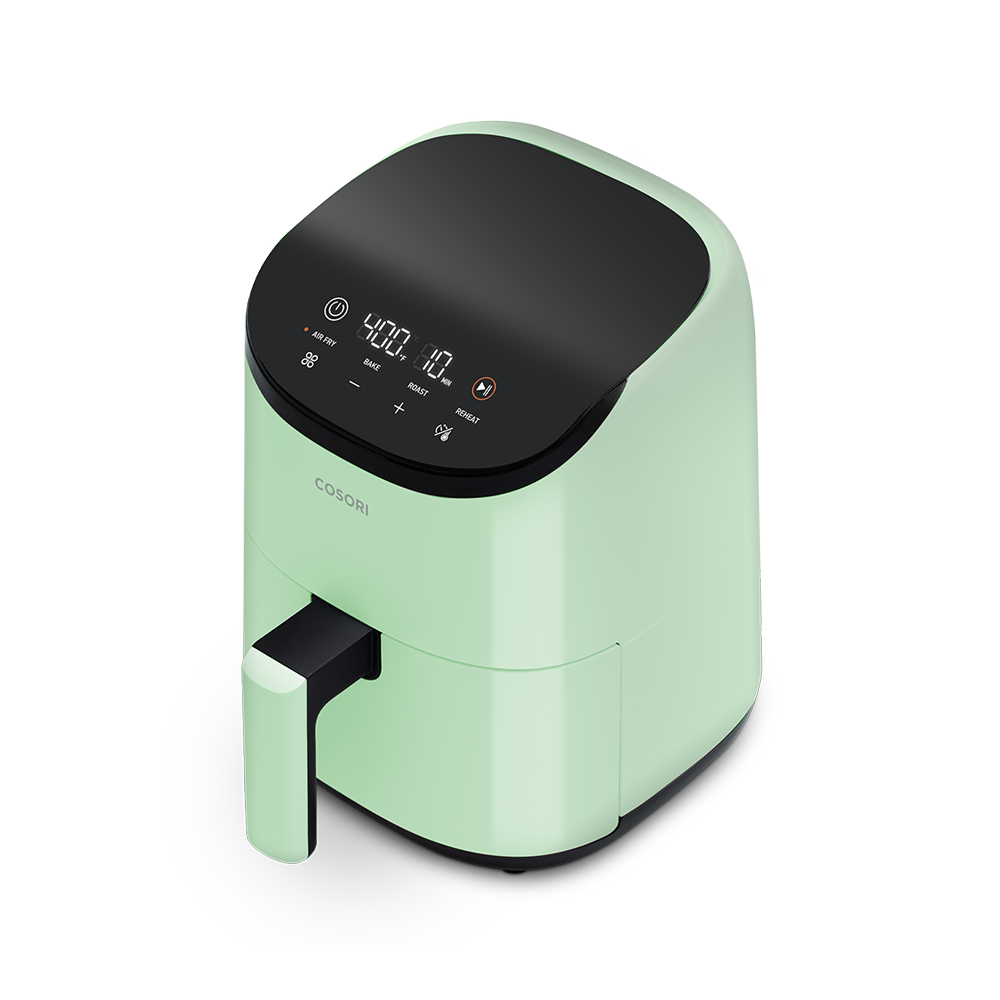 Angled view of the sage green Cosori Lite 2.1-Quart Mini Air Fryer.
